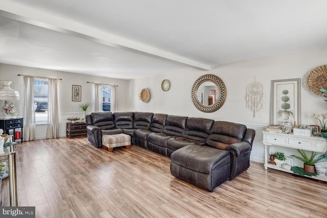 living room featuring light hardwood / wood-style floors and beamed ceiling