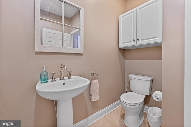 bathroom featuring sink, tile patterned floors, and toilet