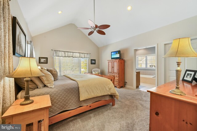 carpeted bedroom featuring ceiling fan, high vaulted ceiling, and ensuite bath