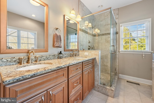 bathroom featuring vanity, tile patterned floors, and walk in shower