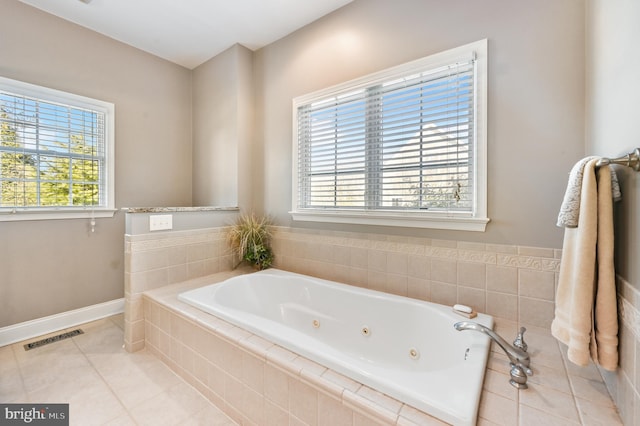 bathroom featuring tile patterned floors and a relaxing tiled tub