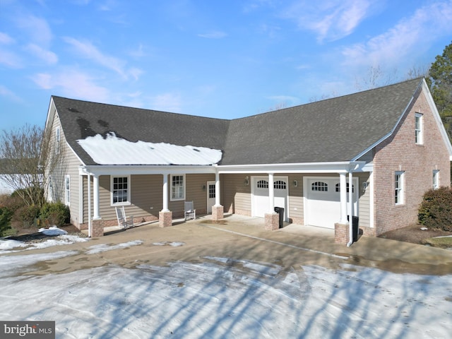 view of front facade with covered porch and a garage