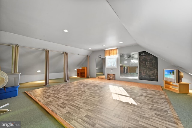 bonus room with vaulted ceiling and carpet floors