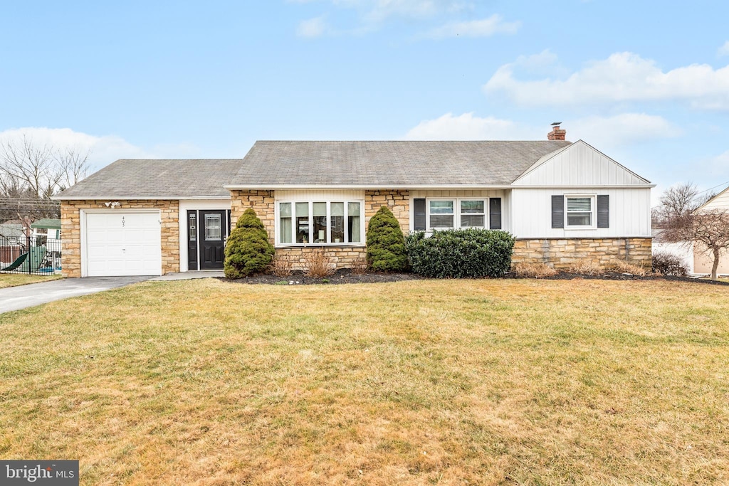 ranch-style house with a garage and a front yard