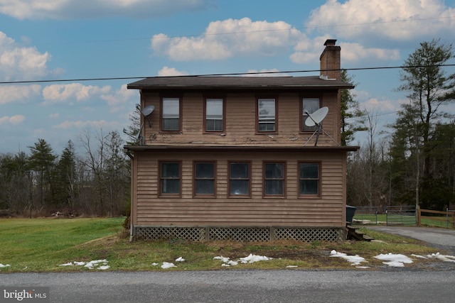 view of property exterior with a yard