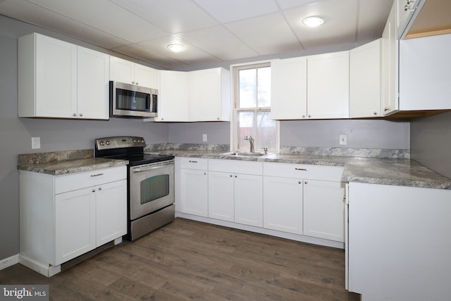 kitchen featuring stainless steel appliances, white cabinets, and sink