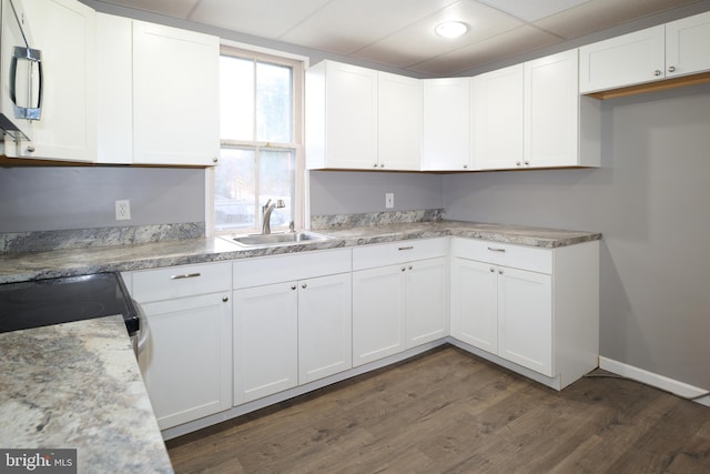 kitchen with sink, white cabinets, and dark hardwood / wood-style floors