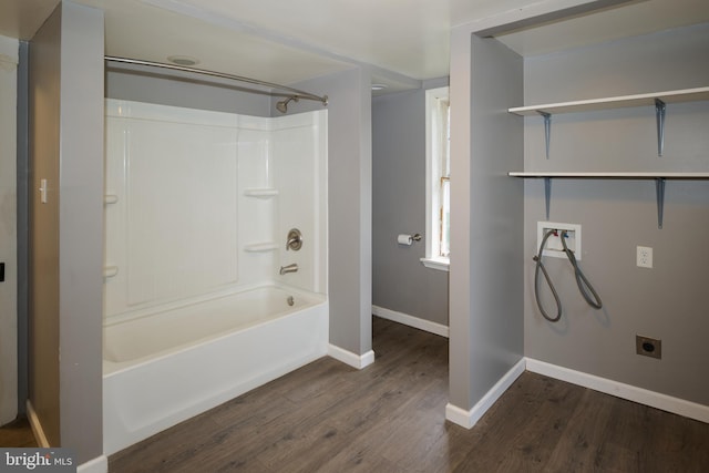 bathroom featuring wood-type flooring and shower / bathtub combination