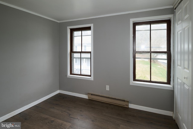 empty room with a baseboard radiator, ornamental molding, and dark wood-type flooring