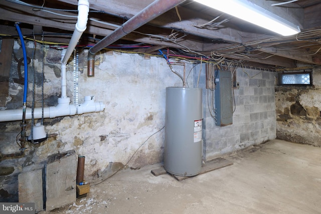 basement with electric panel and electric water heater