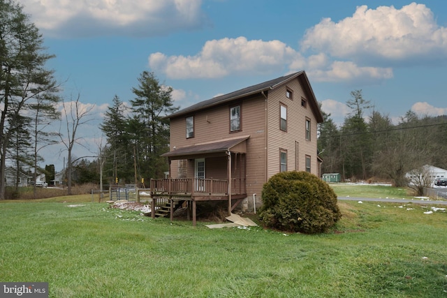 back of property with a yard and a wooden deck