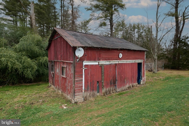 view of outbuilding featuring a lawn