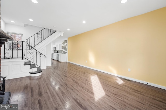 unfurnished living room with wood-type flooring