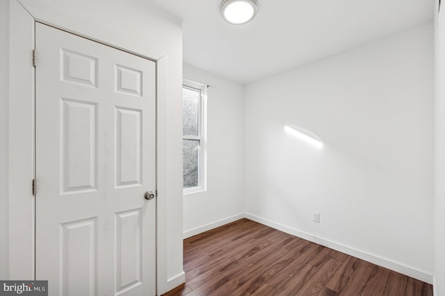 spare room featuring wood-type flooring