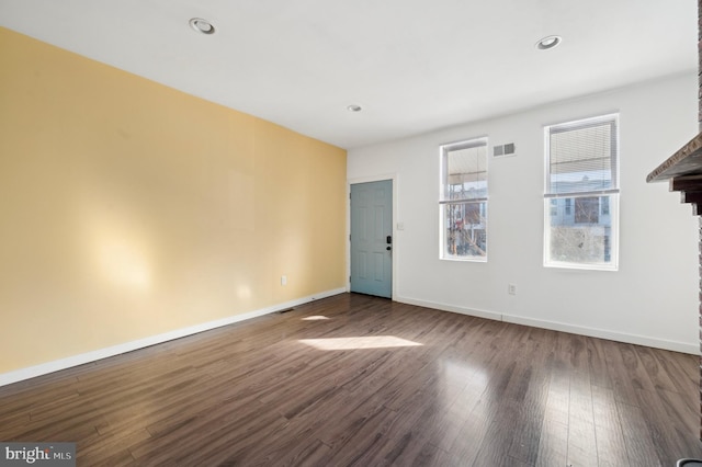 spare room with dark hardwood / wood-style flooring