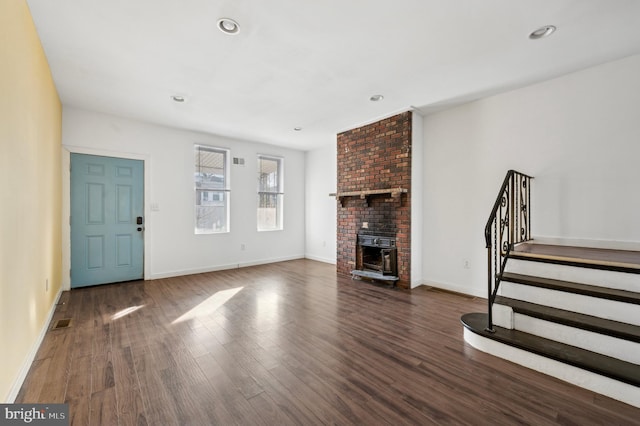 unfurnished living room featuring dark hardwood / wood-style floors