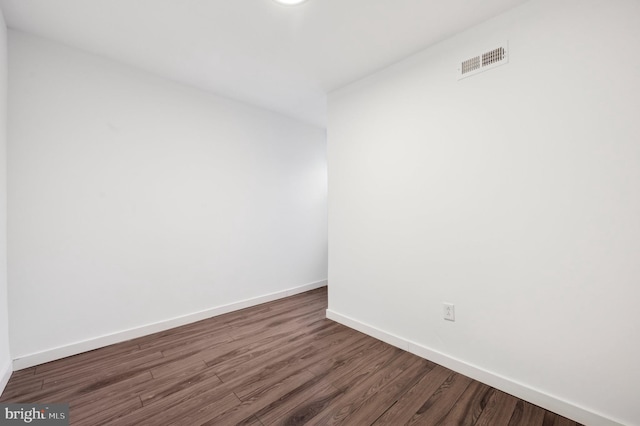 spare room featuring dark wood-type flooring