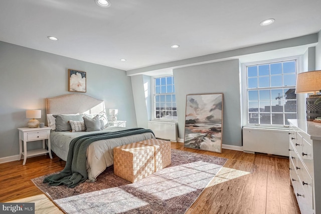 bedroom with multiple windows and light hardwood / wood-style floors