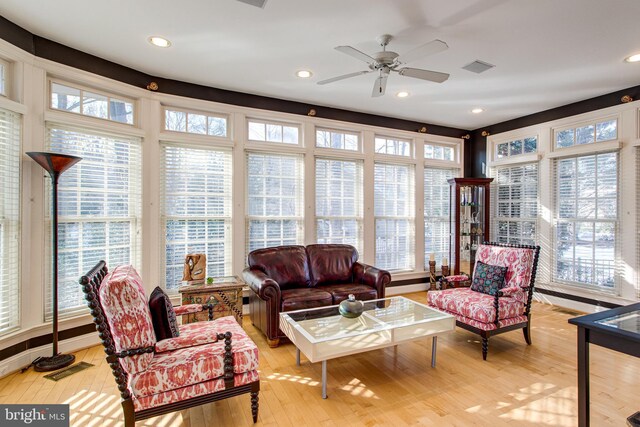 sunroom / solarium with visible vents and ceiling fan