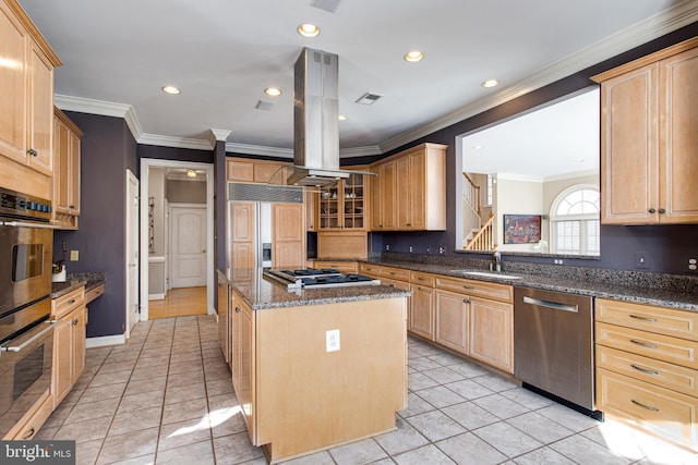 kitchen with dark stone countertops, a center island, a sink, appliances with stainless steel finishes, and island range hood