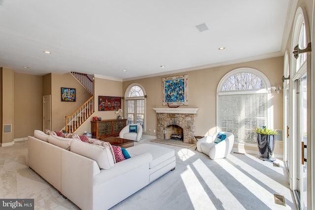 living room featuring a stone fireplace, recessed lighting, stairs, and ornamental molding