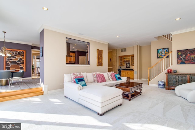 living room featuring stairway, ornamental molding, and carpet flooring