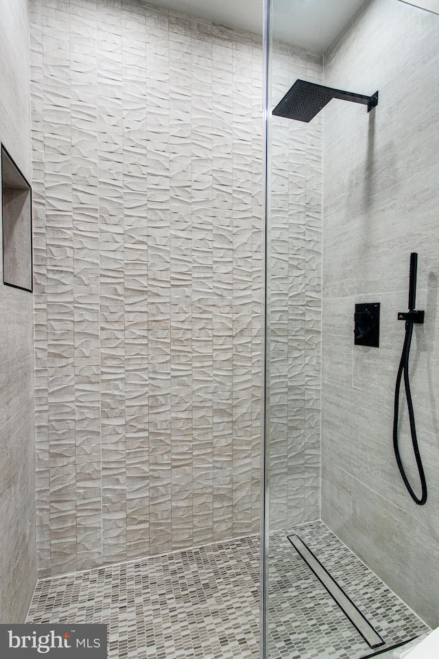 bathroom with tiled shower