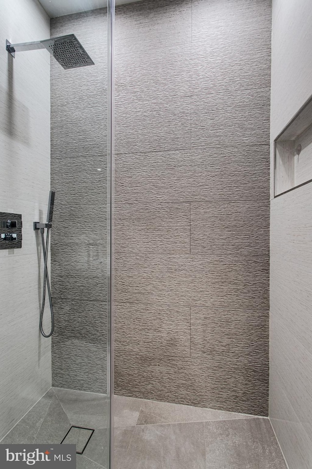 full bathroom with a tile shower