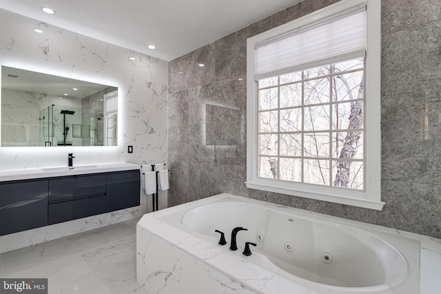 bathroom with a wealth of natural light, a marble finish shower, marble finish floor, and vanity