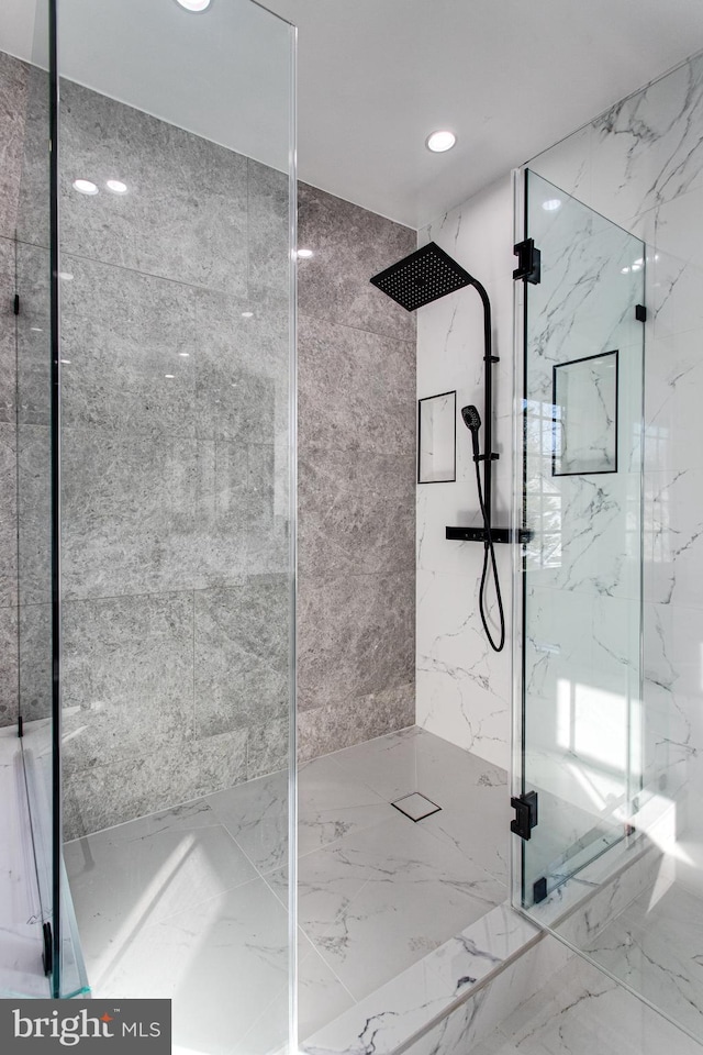 bathroom featuring a marble finish shower, recessed lighting, marble finish floor, and stone wall