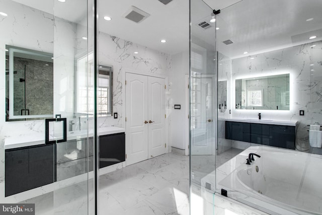 full bath featuring vanity, stone wall, visible vents, and marble finish floor