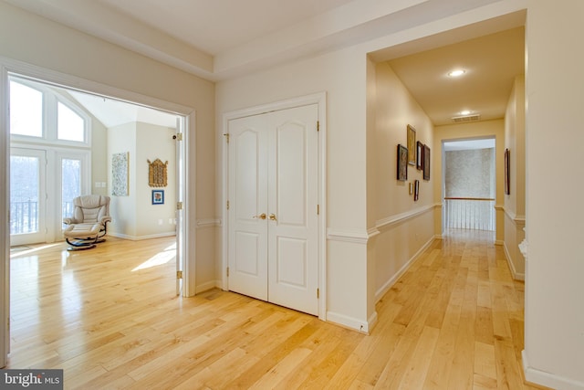 corridor with visible vents, recessed lighting, baseboards, and light wood-style floors