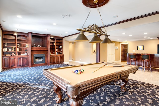 recreation room with ornamental molding, recessed lighting, a bar, a fireplace, and baseboards