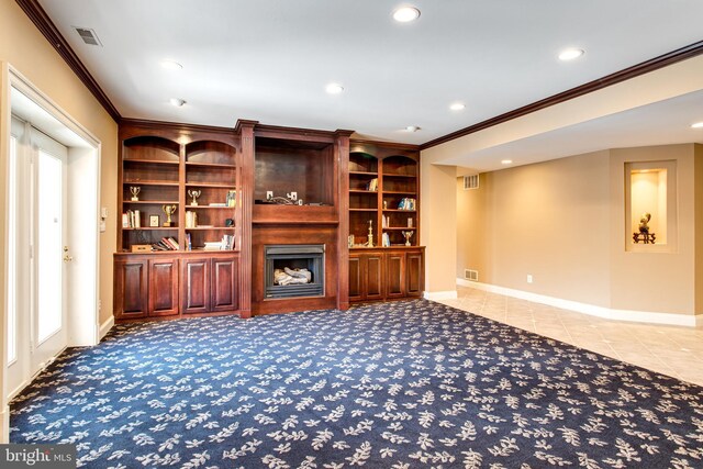 unfurnished living room featuring visible vents, a large fireplace, baseboards, and ornamental molding