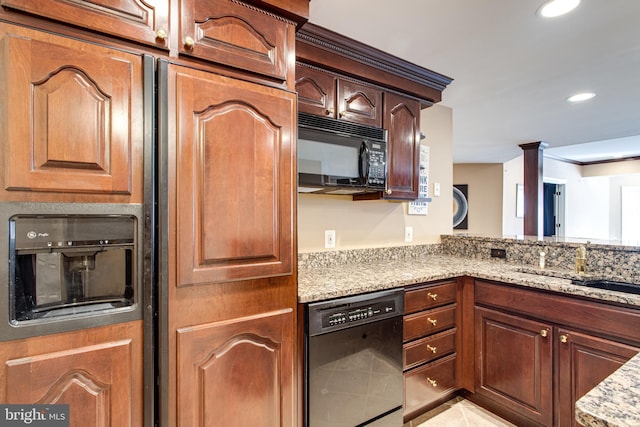 kitchen featuring light stone counters, light tile patterned floors, recessed lighting, a sink, and black appliances