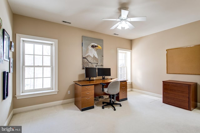 office space with carpet, baseboards, visible vents, and a ceiling fan