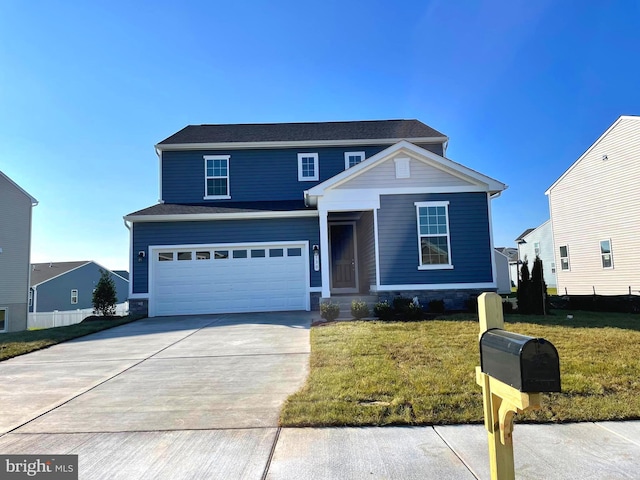 view of property featuring a garage and a front yard