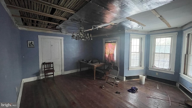 miscellaneous room featuring a chandelier and hardwood / wood-style flooring