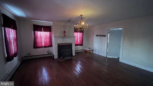 unfurnished living room featuring baseboard heating, an inviting chandelier, and dark hardwood / wood-style flooring