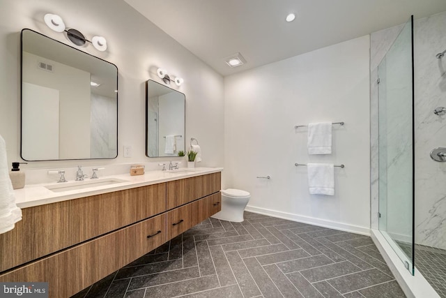 bathroom with walk in shower, vanity, and toilet