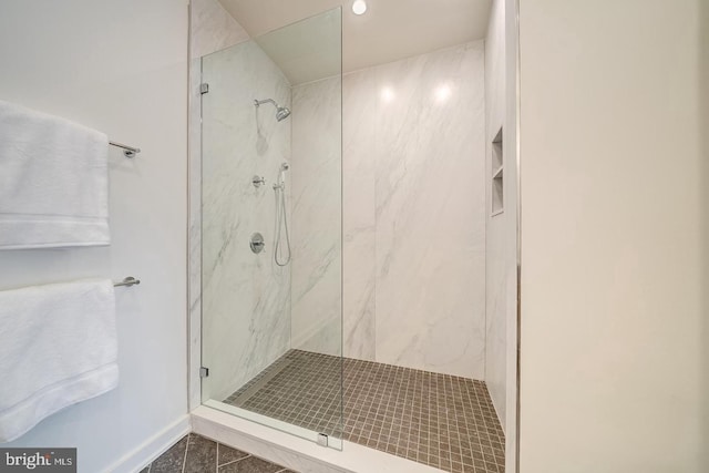 bathroom featuring a tile shower and tile patterned floors