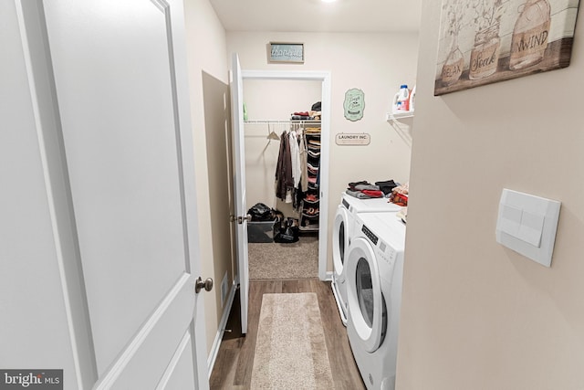 laundry area featuring hardwood / wood-style floors and separate washer and dryer