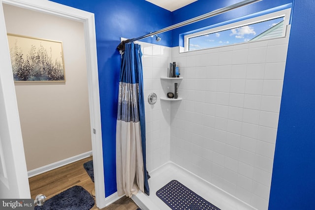 bathroom featuring a shower with shower curtain and wood-type flooring