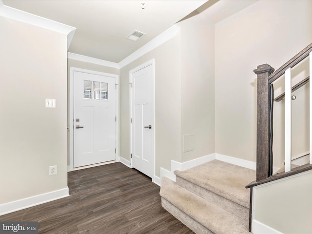 entryway with dark wood-type flooring and ornamental molding