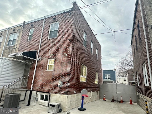 exterior space with central air condition unit and a patio area