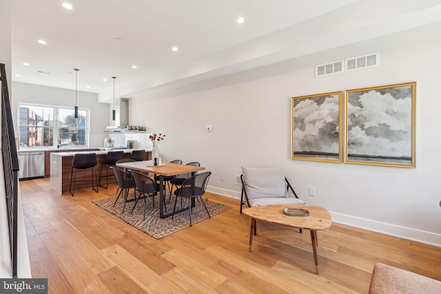 dining space with light wood-type flooring