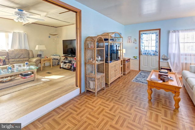 living room featuring ceiling fan and light parquet floors