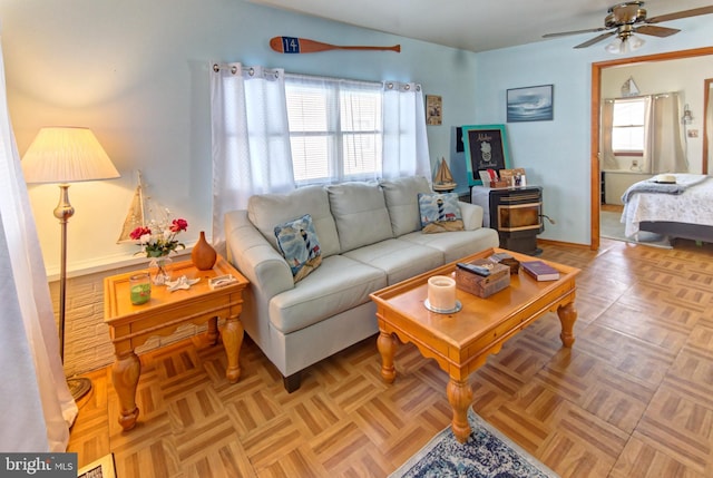 living room featuring light parquet flooring and ceiling fan