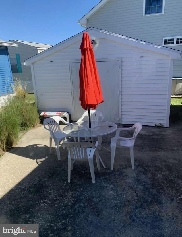 view of patio featuring a storage shed