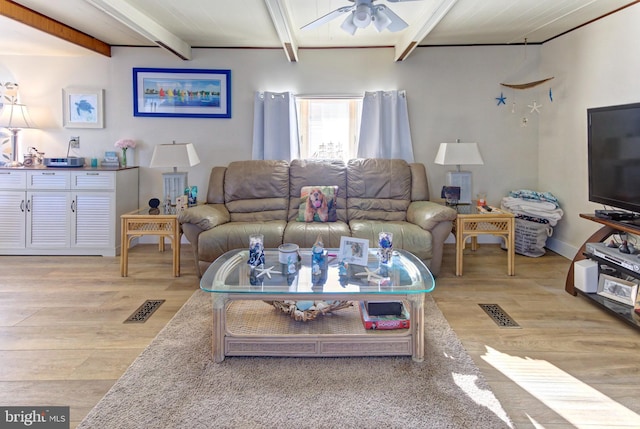 living room with ceiling fan, beam ceiling, and light hardwood / wood-style floors